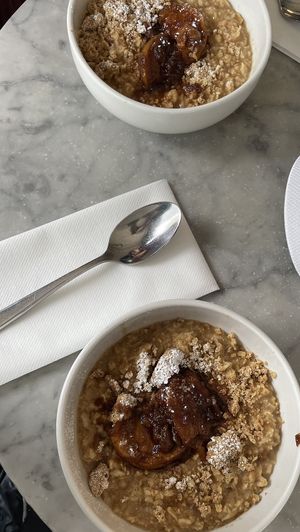 Almond milk porridge with cinnamon stewed apple and crumble   at Grind - Shoreditch in London