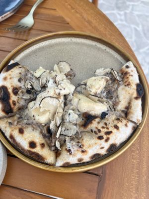 Truffle pizza  at TAAMA Restaurant in Dubai