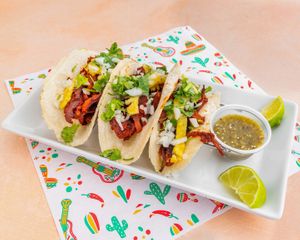 AL PASTOR TACOS
Seitan pork marinated in guajillo sauce, crowned with grilled pineapple, fresh onion, cilantro, and salsa.
 at El Nopalito Vegan Taqueria - Food Stall in Fort Lauderdale