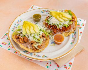 TOSTADAS
Crunchy tortillas with refried beans and your choice of seitan beef, GF soy protein, or squash blossom. Finished with lettuce, sour cream, mozzarella, and avocado. at El Nopalito Vegan Taqueria - Food Stall in Fort Lauderdale