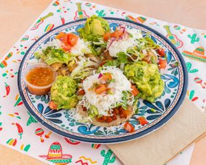Thick corn flour bases layered with refried beans and your choice of protein. Topped with lettuce, sour cream, mozzarella, and served with guacamole and pico de gallo.  at El Nopalito Vegan Taqueria - Food Stall in Fort Lauderdale