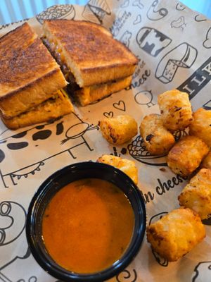 Vegan grilled cheese w/ both cheeses + burger patty, tomato soup and tator tots at I Heart Mac & Cheese in Sacramento