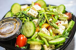 Mixed green salad with house made plant based feta at JUST BE Healthy Meals in Chicago