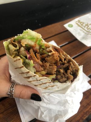 happy vegan eating a vegan döner wrap aka dürüm  at Vegitat - Klybeckstrasse in Basel