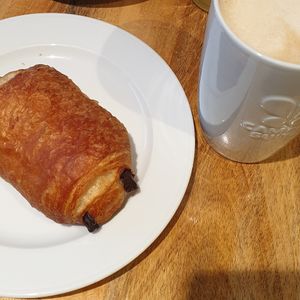 Chocolatine with cafe latte at Campus Suite  in Hamburg
