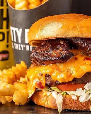 #DanceHallQueen! Grilled Impossible Patty with marinated grilled onions, lettuce, tomatoes, jerk plantains, house chili & Slut sauce. at Slutty Vegan in Baltimore