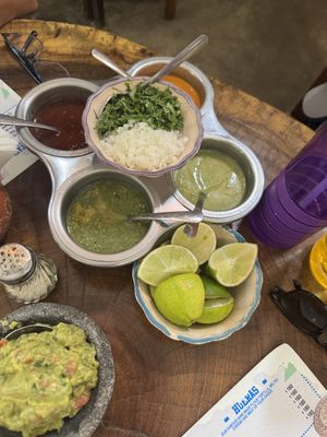 4 salsas, onions, cilantro and lime as toppings for tacos   at Tacos Sonorita Olas Atlas in Puerto Vallarta