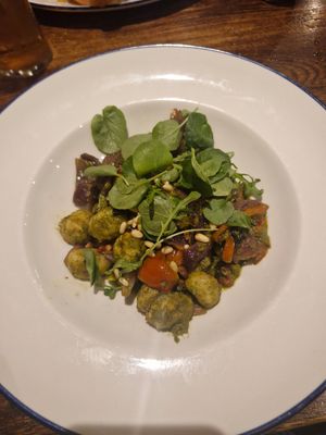 Basil pesto and spinach gnocchi, sunblush tomato, toasted pine nuts, vegan cheese crisps at The Bull's Head in Macclesfield