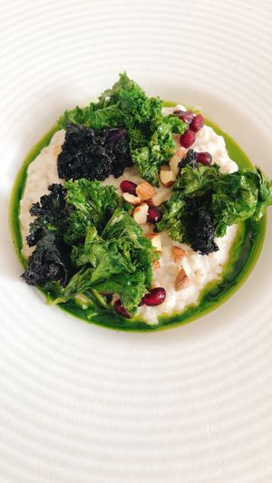 piatto principale di dicembre: sorgotto alla panna di cavolfiore, cavolo riccio spadellato, mandorle al sale e melagrana at La Taverna degli Arna in Milan