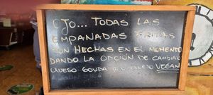 Outside menu stating vegan cheese option at Delicias Express in Valparaiso