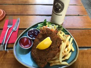 Schnitzel Vienna Style (with French fries and side salad under the schnitzel)  at Bodhi in Munich