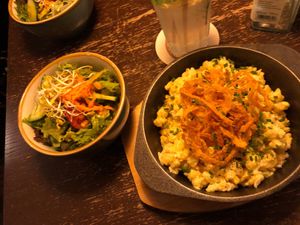 My cheesy dish with onion rings atop and the side salad. at Bodhi in Munich
