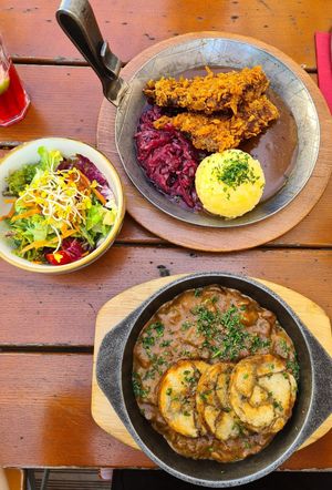 typical bavarian food. Crispy soy steak with potato dumpling and a mushroom ragout with bread dumplings at Bodhi in Munich