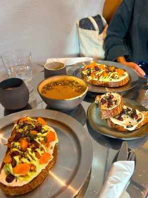 Seasonal sourdough toast (with roasted pumpkin, pickled carrot, tofu 'cheese'), and an umami tasty carrot cream soup.  at 201 STUDIO in Zagreb