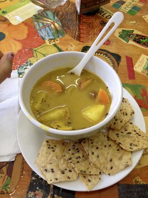 Vegan soup made with potatoes, carrots, chickpeas and other things that I can't remember. It looks half full because I started eating it before taking the picture (I was hungry). It was very delicious.  at La Chiwinha in San Juan