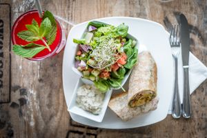 Falafel burger wrap w/ side mixed green salad and strawberry mint lemonade at Island Naturals Cafe in Seven Mile Beach