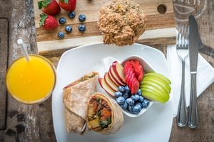 Breakfast Options Including A Hearty Breakfast Wrap w/ side of fresh fruit, gluten-free muffin and freshly squeezed juice. at Island Naturals Cafe in Seven Mile Beach