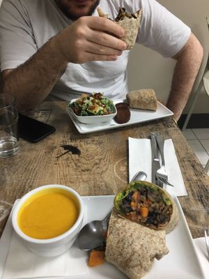 Two BBQ burritos with soup and salad sides  at Island Naturals Cafe in Seven Mile Beach