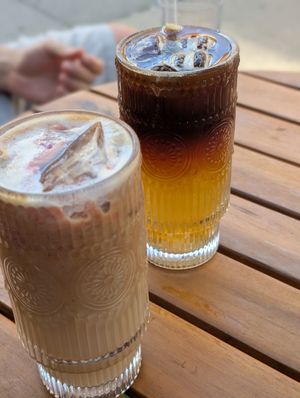Strawberry Butterfly Pea Latte (where are the strawberries and where is the butterfly pea?) and coconut water latte in the back (super sweet) at Kosmic Community Anti Bar & Coffee Shop in New York City