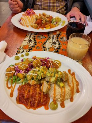 Two different vegan dishes in the photo: Maira and vegan version of Attieke. Both have "no-chicken" in them. Senegalese style ginger-pinapple juice and hibiscus juice at the side. at Maira African Soul Food in Tampere