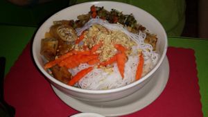 Noodle bowl with vegan egg roll at Lotus Vegetarian in Denver