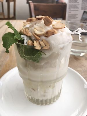 Coconut ice cream with syrup, roasted peanuts and fresh coconut shavings. Ask for no honeycomb to make it vegan (it’s labelled vegan on the menu but includes honeycomb).  at Jaan Bai Restaurant - CCT in Battambang