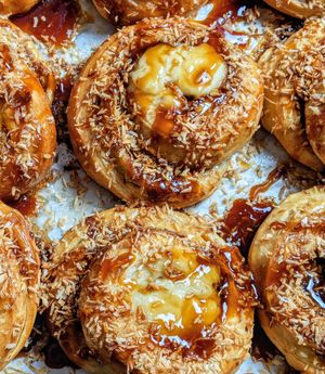 Sun buns – brioche buns filled with vanilla bean custard, dipped and toasted coconut, and drizzled in caramel at Twisted in Amherst