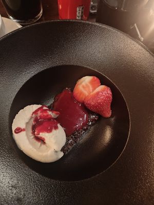 Vegan chocolate brownie with ice cream and berries. at Glada Stinsen in Stockholm