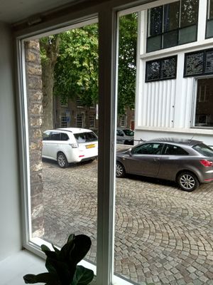 A view from the cafe  towards a small square and historic buildings (August 2025) at Espresso Quartier in Maastricht