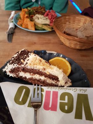Vegan "snickers" cake and antipasti plate (background) at Vengo Die Gemusekuche in Bremen
