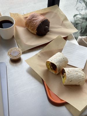 black coffee, vegan chocolate croissant, vegan breakfast burrito  at mu.sō coffee  in Los Angeles