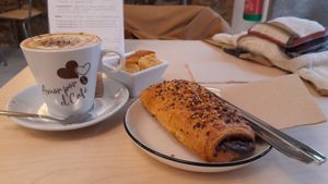 Coffee and pain au chocolate at Black Cat Santiago in Santiago De Compostela