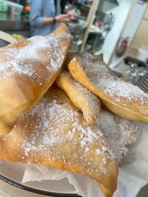 Orellas . Typical carnival fried dough with lemon,  anis… at Black Cat Santiago in Santiago De Compostela