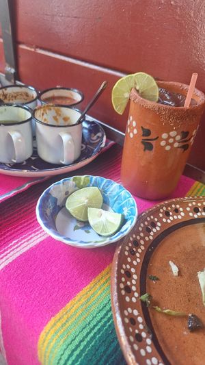 Una Mezcalita refrescante y salsitas para acompañar at DeAca Restaurante in Mexico City