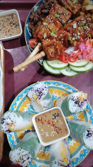 Fresh spring rolls with creamy peanut sauce & and Buddha bowl with rice of choice (coconut rice is a bestseller!), veggies, our pickles and hoisin tofu 💚 at Herbalist by Nitevo Reggae Bar and Restaurant in San Vicente Palawan