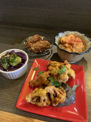 Cabbage and sprouts, avocado nuggets, cauliflower curry tofu and cauliflower with charcoal sauce at Base Island Kitchen in Osaka