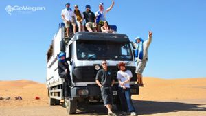 Group photo in the Sahara Desert at GoVegan Travel in Ilford