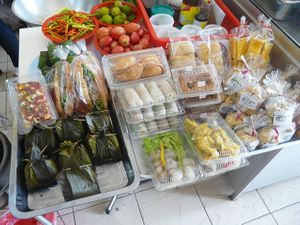 Small table with sandwiches, cookies, springroll, pizza bread, etc. at Jay - City Center in Udon Thani