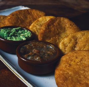 Sopaipillas veganas, una receta tradicional chilena elaborada con calabaza, harina, aceite de oliva y sal. Acompañada con chancho en piedra y aguacate machacado at rhuka in Madrid