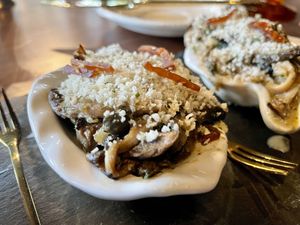 Closeup. Topping is an herb gremolata, Parmesan and capers.  at Marian Cocktails and Kitchen in Raleigh