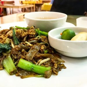 Char kway teow with spring rolls and soup at Loving Hut in Central Singapore