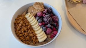 Porridge bowl with chia seeds, banana, frozen berries, biscoff crumb, and peanut butter at blend in Newquay