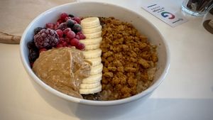 Porridge with banana, frozen berries, peanut butter, and crumbled biscoff  at blend in Newquay