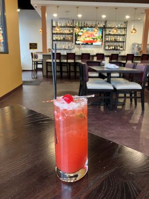 Virgin Strawberry Mojito with the full bar in the background. at Saffron Indian Grill & Bar in Eagan
