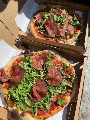 Top Pizza: PLEION - arugola (rocket), red pepper, vegan prosciutto, and vegan blue cheese. // Bottom Pizza: CALLISTO - Olives, arugola (rocket), vegan prosciutto, and vegan cheese  at Pizzeria L'Angelo in Venice