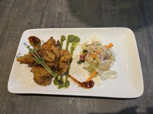Sabzi Ke Pakode (vegetables fried in chickpea flour) with a tiny salad and 3 different kinds of sauces.  at Indian Village in Gothenburg