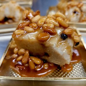 Traditional Diné style White corn cake .
Made with stone ground, roasted Diné white corn, wild harvested pinon nuts, organic agave caramel.  at Ch'il Indigenous Foods - Pre-order in Wheat Ridge