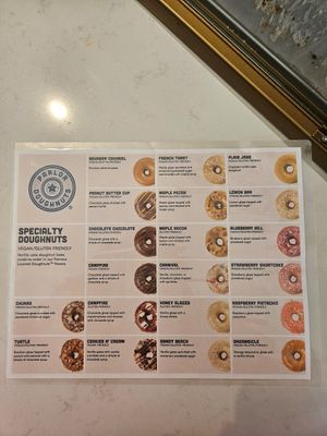 Variety of flavors 2ith the vegan ones clearly marked at Parlor Doughnuts in Bolingbrook