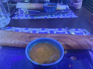 Dosa (pancake) and it's pot of sauce at Bites of India Botanic in Belfast