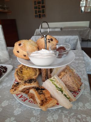 Savoury goodies (tofu-egg mayo and coronation chickpea sandwiches, plus sausage rolls and quiche) and chocolate chip scones with chocolate spread and cream! at All Good Things Vegan in Paignton